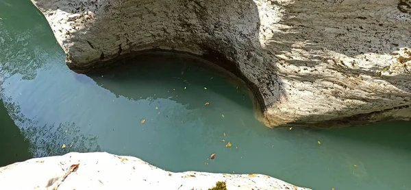 Turquoise water of a mountain river between white rocks