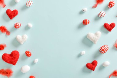 Paskalya kartı, tüylü kırmızı-beyaz yumurtalar ve mekânın bir kopyasıyla örülmüş kalpler. Paskalya bayrağı. Şenlik arka planı. Uzayı kopyala Düz yatış, üst görünüm.