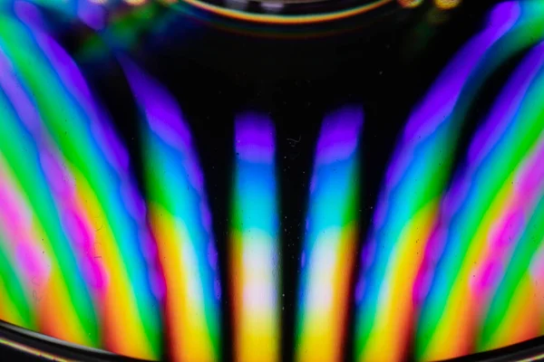 Drops of water on a CD create an explosion of color and a rush for the senses