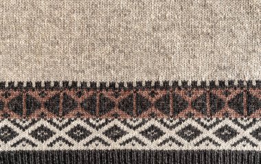 El yapımı yün kremi kumaşının arka planı ve desenli kahverengi renkler, kumaş örgü dokusu.