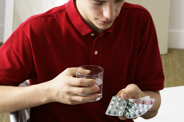 MAN TAKING MEDICATION