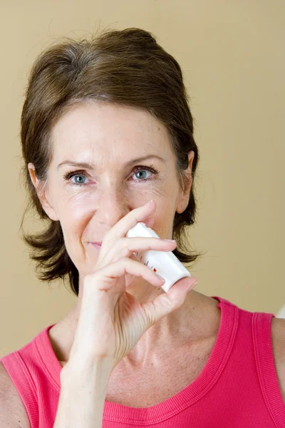 ELDERLY PERSON USING NOSE SPRAY — Stock Photo, Image