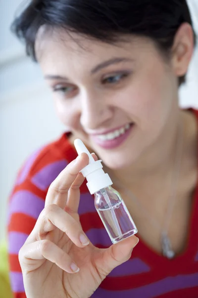 WOMAN USING NOSE SPRAY — Stock Photo, Image