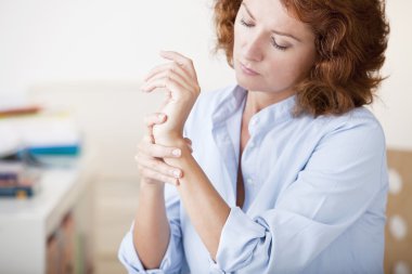 PAINFUL WRIST IN A WOMAN clipart