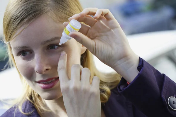 Vrouw met behulp van oog lotion — Stockfoto