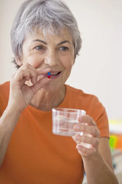 ELDERLY PERSON TAKING MEDICATION — Stock Photo, Image