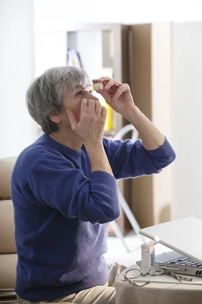 PESSOA SUPERIOR UTILIZANDO A LOÇÃO DOS OLHOS — Fotografia de Stock