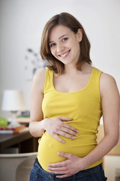 PREGNANT WOMAN INDOORS Stock Picture