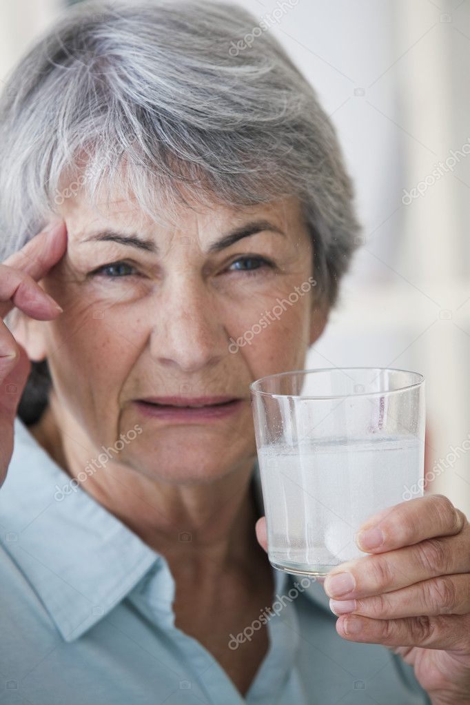 elderly person taking medication