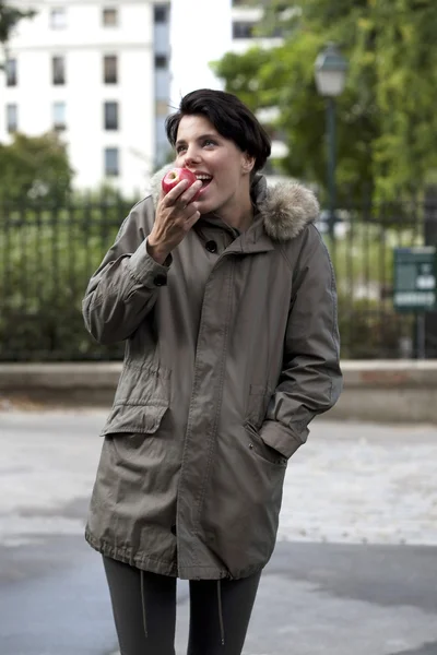 Girl eating an apple — Stock Photo, Image