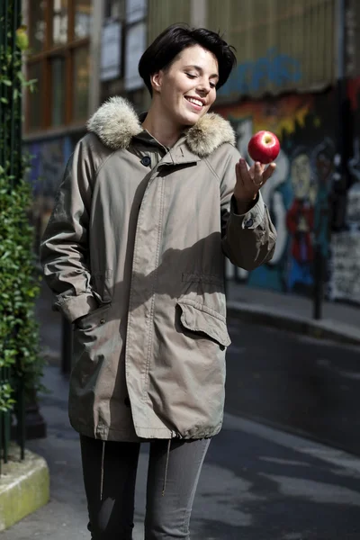 Woman throws up an apple — Stock Photo, Image