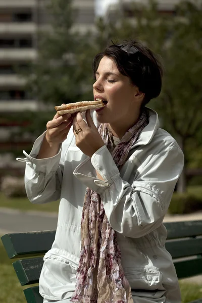 Girl eating sandwich — Stock Photo, Image