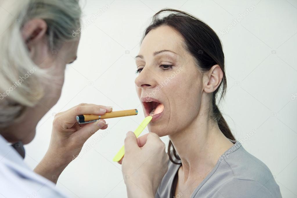 ENT examining patient's throat