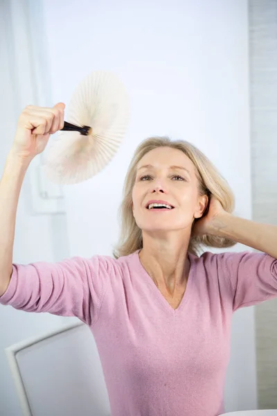 Menopausal Woman Having Hot Flush — Stockfoto