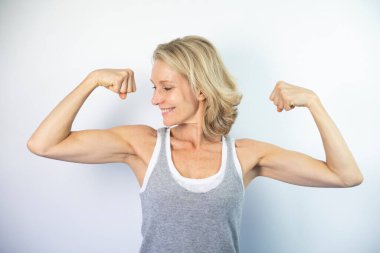 A woman looking at her muscles.