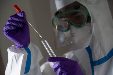 Man in protective suit during Covid-19 pandemic with PCR test