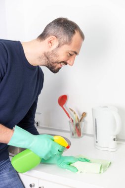 A man using cleaning products to clean.