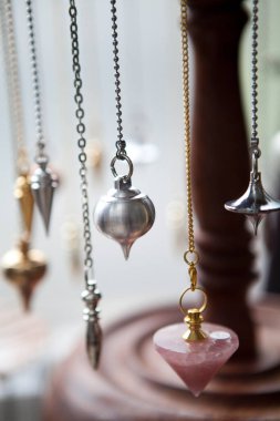 Pendulums being used for the exercise of the trade of healer dowser and magnetizer.