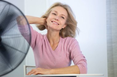 A menopausal woman having a hot flush.