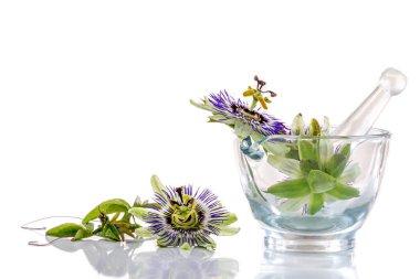 Image of passionflowers in a glass mortar isolated on white background. clipart