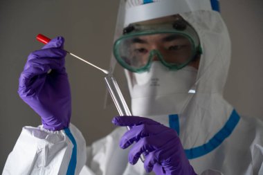 Man in protective suit during Covid-19 pandemic with PCR test
