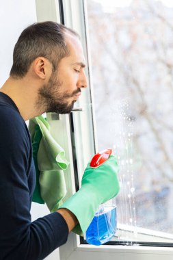 A man cleaning a window.