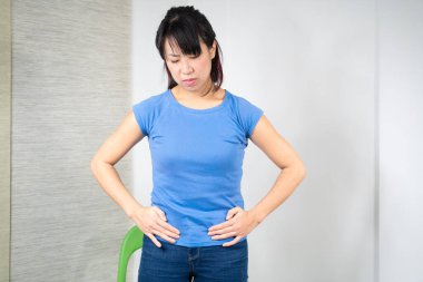 Asian woman having painful period.
