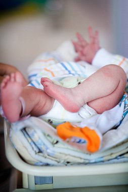 Level 2 neonatal ward of a hospital, weighing a premature baby.
