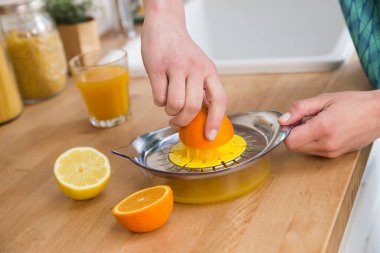 Woman preparing fresh fruit juice.
