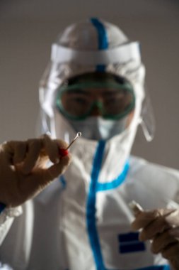 Medical personnel performing an antigen test for covid-19.