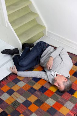 Elderly man who has fallen down stairs.