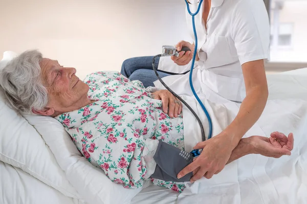 Doctor Measuring Patient Blood Pressure — 스톡 사진