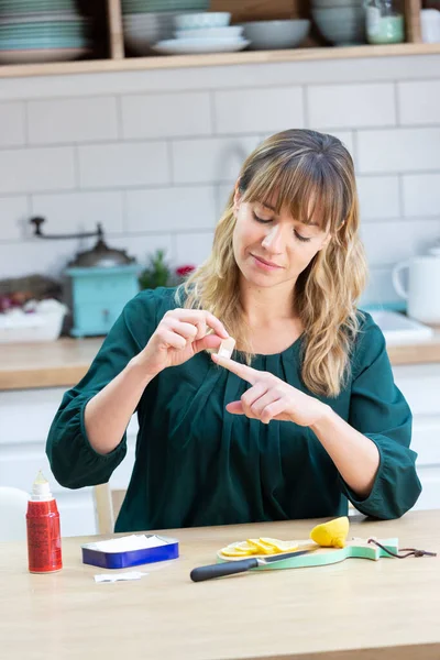 Young Woman Her Kitchen Putting Bandaid Cutting Herself — ストック写真