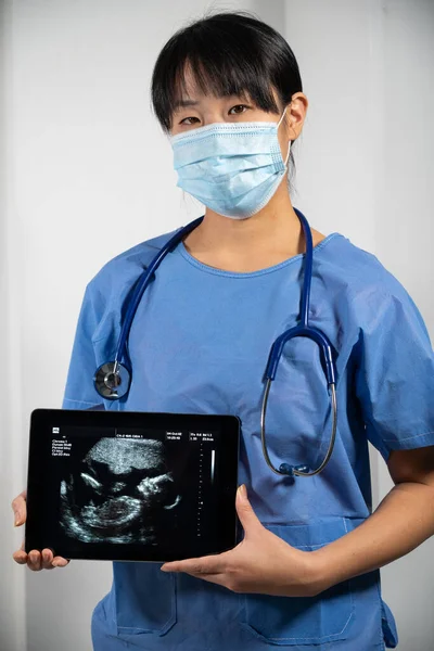 Female Doctor Holding Screen Fetal Ultrasound — Stock Fotó