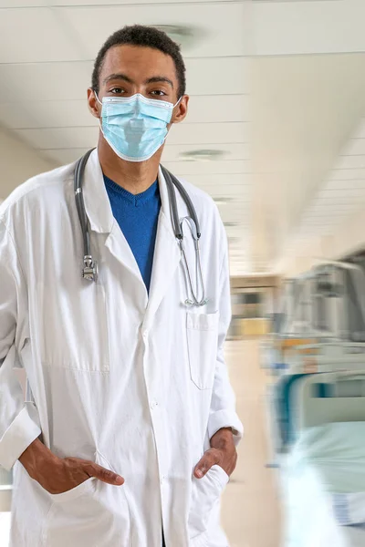 Portrait of a doctor in hospital and sanitary rules, wearing a mask.