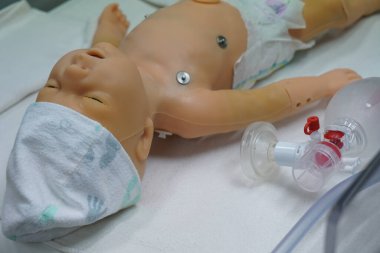 New born mannequin during a pediatric resuscitation simulation workshop.