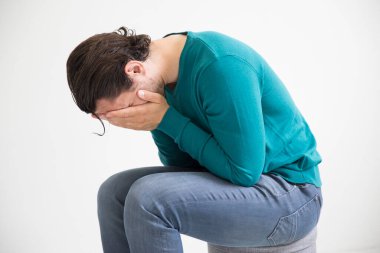 Depressed man on studio background