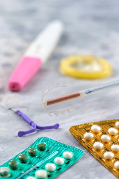 Close-up of IUDs, birth control pills and other means of contraception.