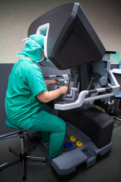 Surgeon piloting a surgical robot from the console.