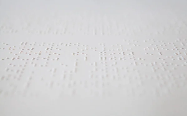 White patent exercises offered in Braille (tactile writing system) to young people who are blind or visually impaired.