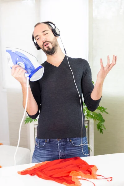 Man Ironing While Listening Music Singing — Stok fotoğraf