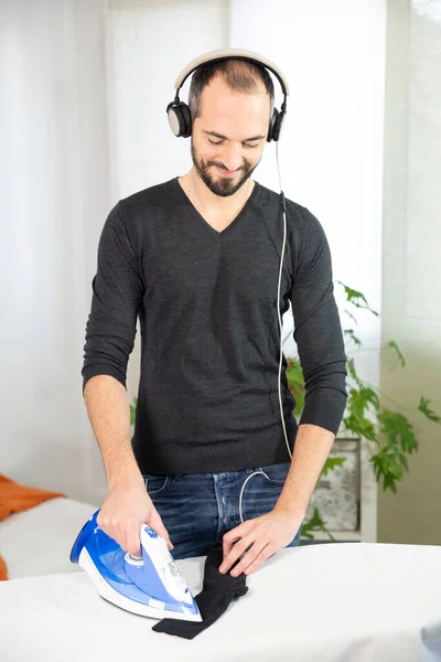 Man Ironing While Listening Music Smiling — Stok fotoğraf