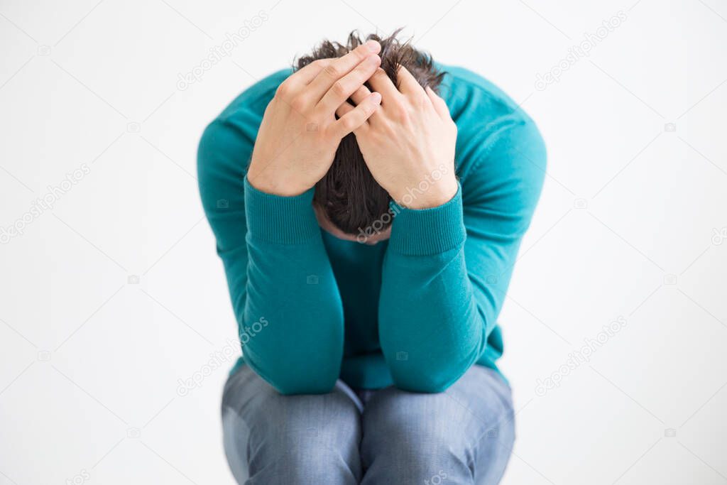 Depressed man on studio background