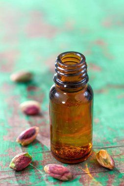 Brown bottle of essential oil of pistachio for herbal therapy.