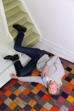 Elderly man who has fallen down stairs.