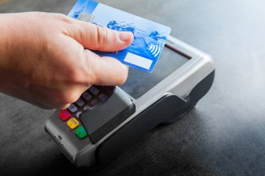 Woman paying with a contactless bank card.