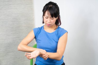 Asian woman having wrist pain
