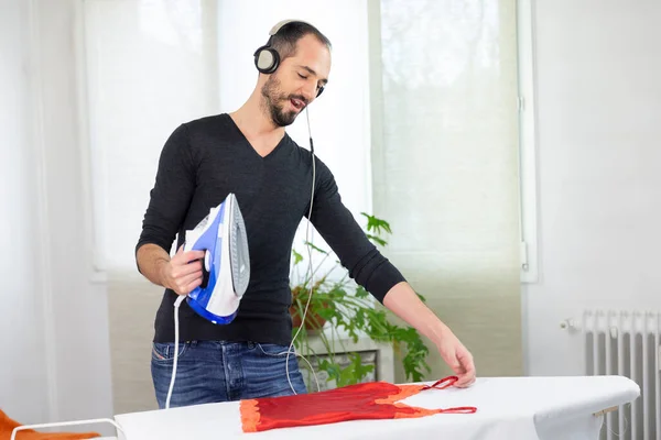 Man Ironing While Listening Music Singing — Stock Fotó