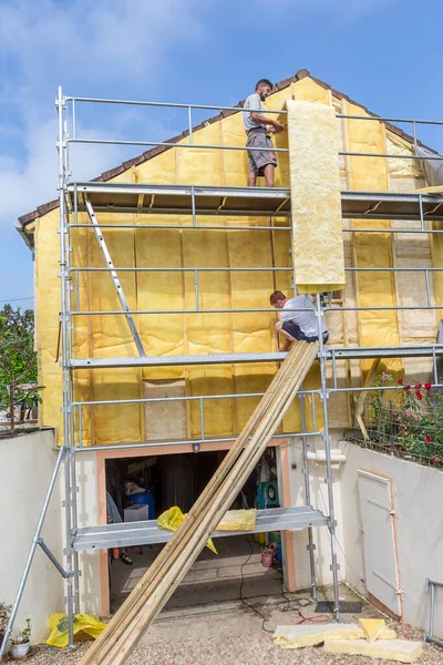 Wall insulation, scaffolding, carrying out aerial work, insulation of facades, building material, building facing work.