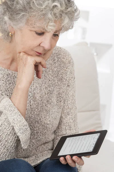 Senior Woman Reading Ebook — Stockfoto